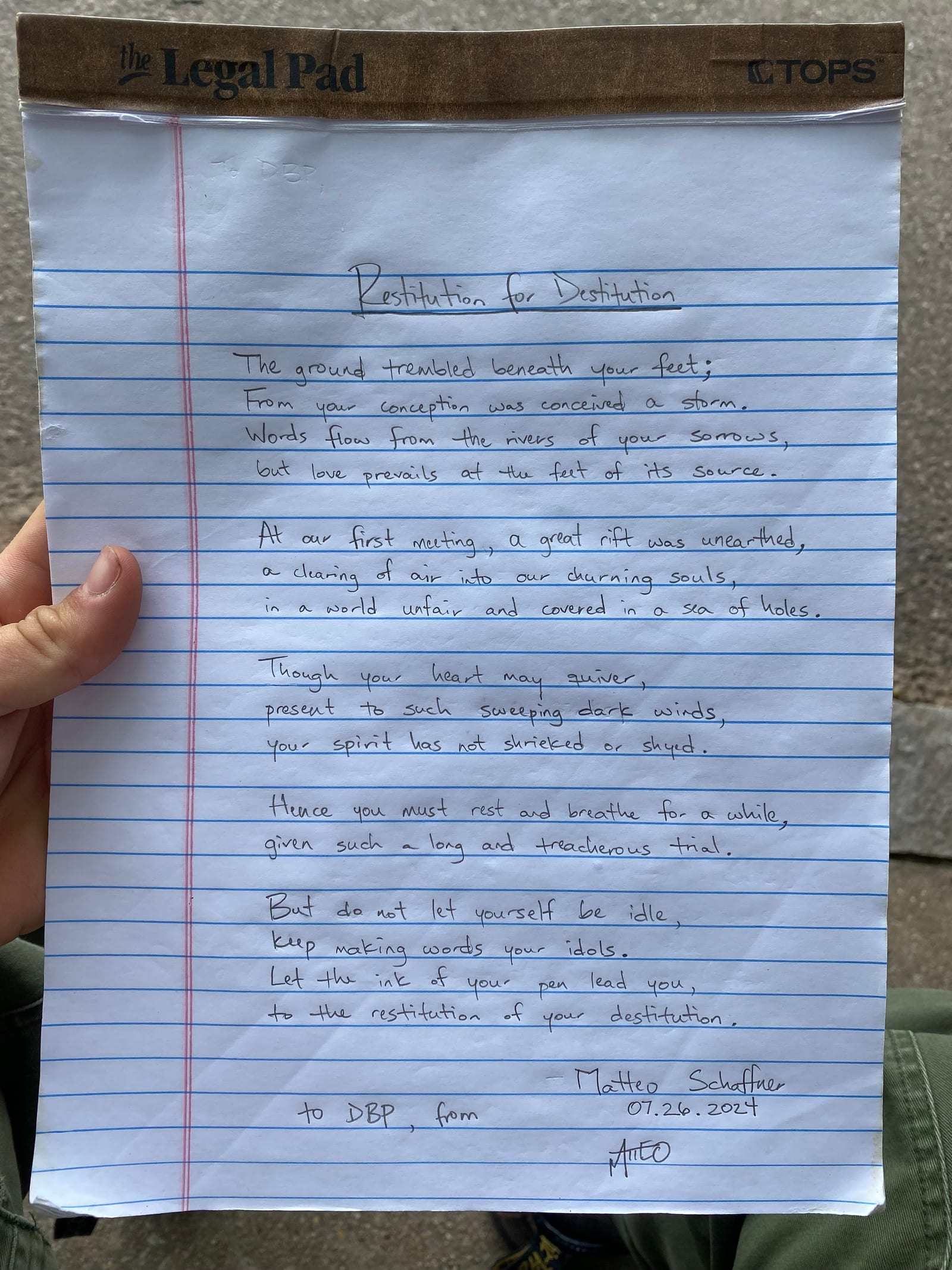 Handwritten poem photographed on notebook paper.